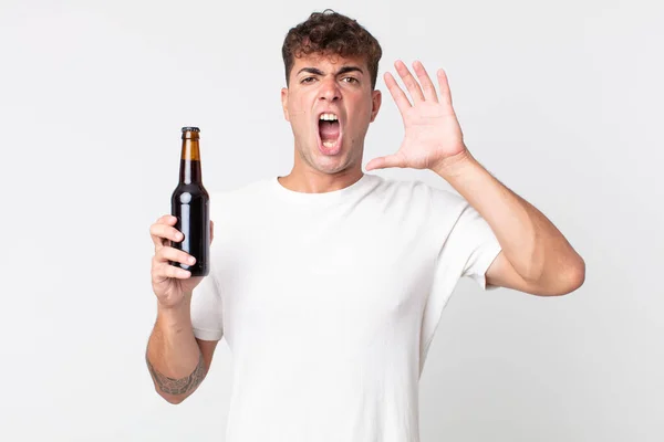 Jovem Bonito Homem Gritando Com Mãos Segurando Uma Garrafa Cerveja — Fotografia de Stock