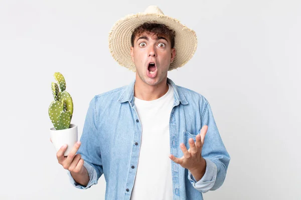 Young Handsome Man Feeling Extremely Shocked Surprised Farmer Holding Decorative — Stock Photo, Image