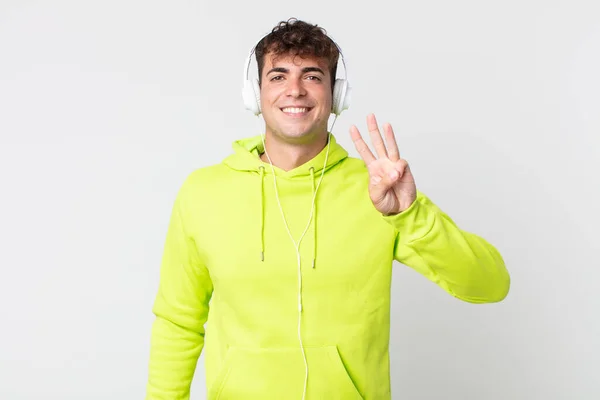 Jovem Bonito Homem Sorrindo Olhando Amigável Mostrando Número Três Fones — Fotografia de Stock