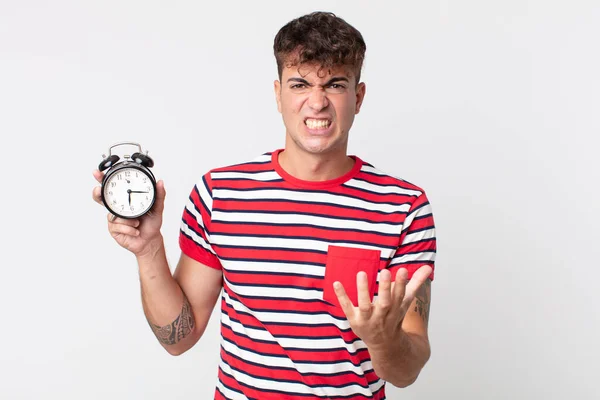 Joven Guapo Hombre Mirando Enojado Molesto Frustrado Sosteniendo Reloj Despertador — Foto de Stock