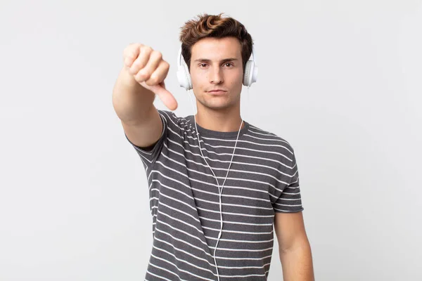 Young Handsome Man Feeling Cross Showing Thumbs Listening Music Concept — Stock Photo, Image