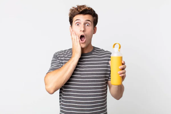 Young Handsome Man Feeling Shocked Scared Holding Coffee Thermos — Stock Photo, Image