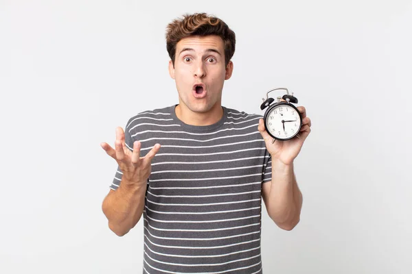 Young Handsome Man Amazed Shocked Astonished Unbelievable Surprise Holding Alarm — Stock Photo, Image