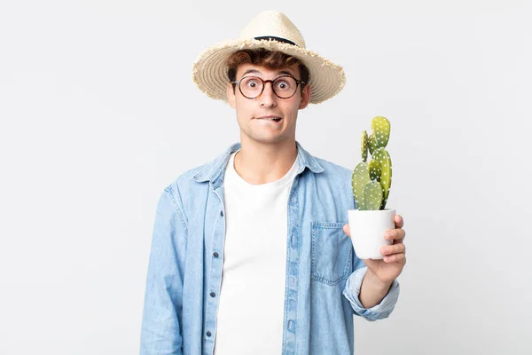 Joven Hombre Guapo Buscando Desconcertado Confundido Agricultor Que Posee Cactus —  Fotos de Stock