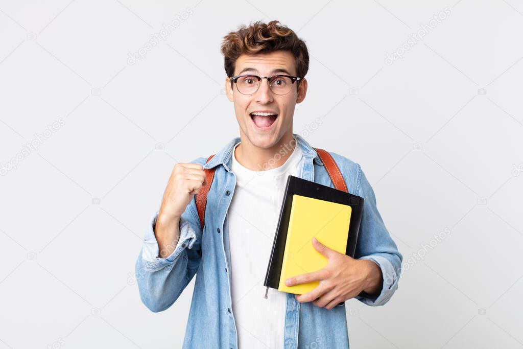 young handsome man feeling shocked,laughing and celebrating success. university student concept