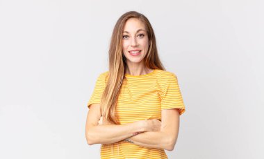 Kollarını kavuşturup gülümseyen mutlu, gururlu ve memnun bir kadın gibi görünen zayıf bir kadın.