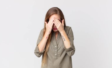 Oldukça zayıf bir kadın üzgün, hayal kırıklığına uğramış, gergin ve depresif, iki eliyle yüzünü kaplayan, ağlayan