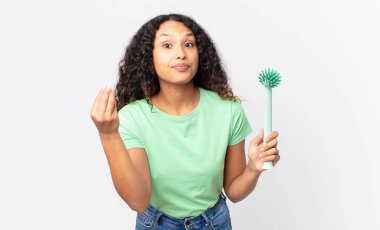 İspanyol güzel kadın kapiş ya da para hareketi yapıyor, sana ödemeni ve bulaşık fırçası tutmanı söylüyor.