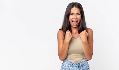 Oldukça zayıf İspanyol bir kadın sinirli bakışlar ve sıkı yumruklarla agresif bağırıyor.