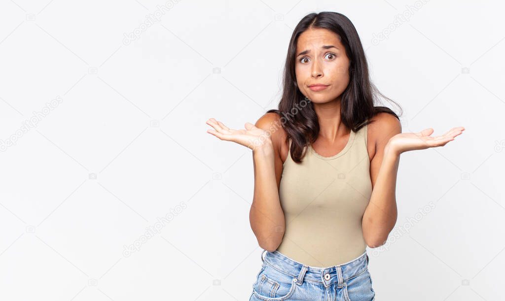 pretty thin hispanic woman feeling puzzled and confused and doubting