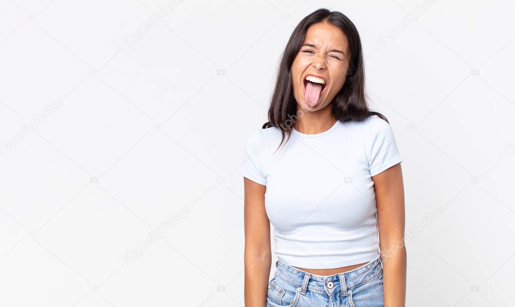 pretty thin hispanic woman with cheerful and rebellious attitude, joking and sticking tongue out