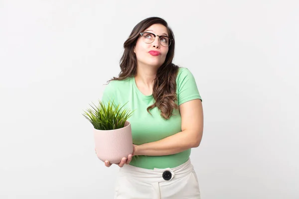 Pretty Woman Shrugging Feeling Confused Uncertain Holding Decorative Plant — Stock Photo, Image
