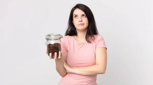 Pretty Woman Shrugging Feeling Confused Uncertain Holding Coffee Beans Bottle — Stock Photo, Image