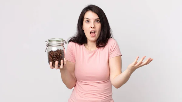 Pretty Woman Feeling Extremely Shocked Surprised Holding Coffee Beans Bottle — Stock Photo, Image