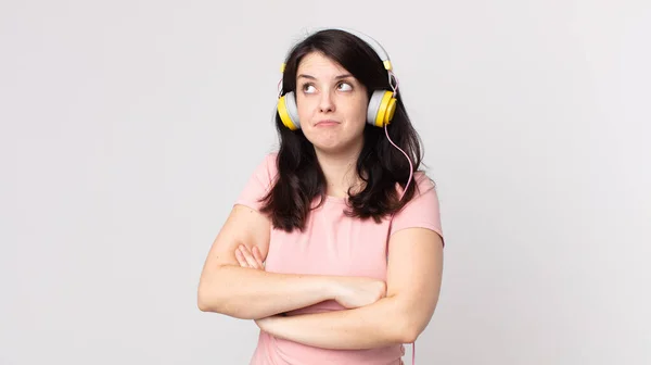 Mooie Vrouw Shrugging Zich Verward Onzeker Luisteren Muziek Met Hoofdtelefoon — Stockfoto