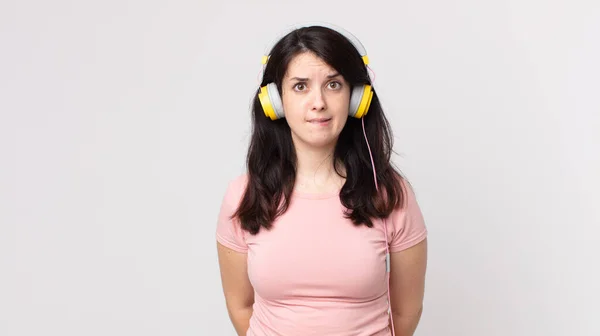 Vacker Kvinna Ser Förbryllad Och Förvirrad Lyssna Musik Med Hörlurar — Stockfoto