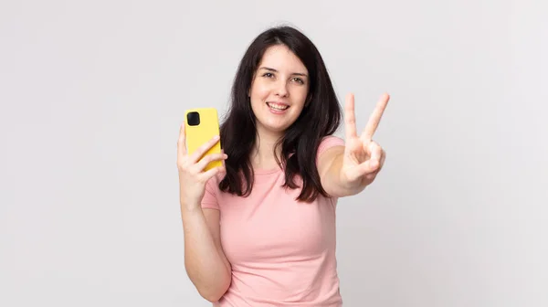 Pretty Woman Smiling Looking Friendly Showing Number Two Using Smart — Stock Photo, Image