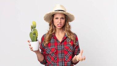 Kaktüs tutan oldukça zayıf, kızgın, sinirli ve hayal kırıklığına uğramış bir kadın. çiftçi kavramı