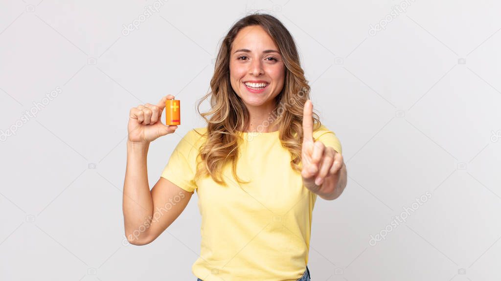 pretty thin woman smiling proudly and confidently making number one and holding batteries