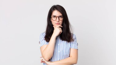 Güzel bir kadın ciddi görünüyor, kafası karışık, kararsız ve düşünceli, seçenekler ve seçimler arasında şüpheci.