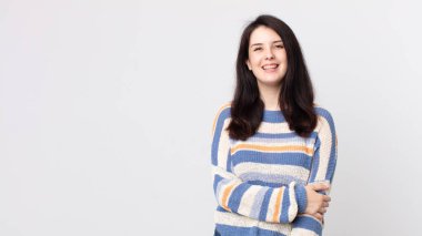 Güzel bir kadın utangaç ve neşeli bir şekilde gülüyor, arkadaş canlısı ve olumlu ama güvensiz bir tavırla.