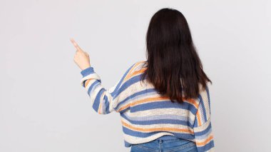 Güzel bir kadın dikey görünüm ve kopya alanı üzerinde duran ve nesneyi işaret eden