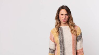 pretty thin woman feeling puzzled and confused, with a dumb, stunned expression looking at something unexpected