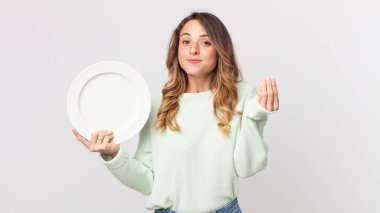 Oldukça zayıf bir kadın kapiş ya da para hareketi yapıyor. Sana ödemeni söylüyor ve elinde boş bir tabak tutuyor.