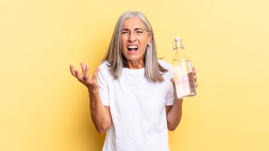 Kızgın, sinirli ve hayal kırıklığına uğramış bir haldesin. Neyin var senin? Elinde bir su şişesi var. 