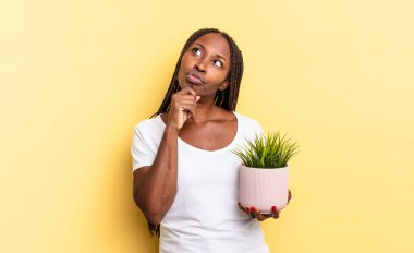 Düşünüyorum, kuşkulanıyorum ve kafam karışık, farklı seçeneklerim var, saksı tutarak hangi kararı vereceğimi merak ediyorum.