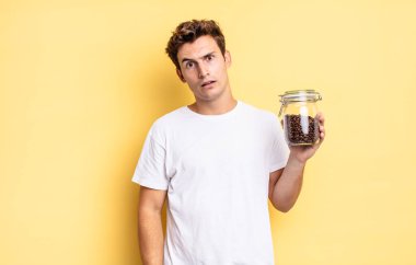 feeling puzzled and confused, with a dumb, stunned expression looking at something unexpected. coffee beans concept