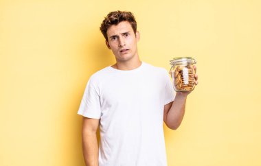 feeling puzzled and confused, with a dumb, stunned expression looking at something unexpected. homemade cookies concept