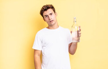 feeling puzzled and confused, with a dumb, stunned expression looking at something unexpected. water bottle concept