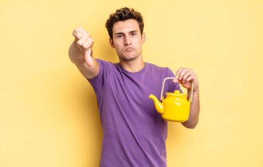 Kızgın, sinirli, hayal kırıklığına uğramış ya da hoşnutsuz, ciddi bir bakışla başparmaklarını aşağı gösteren. çaydanlık konsepti