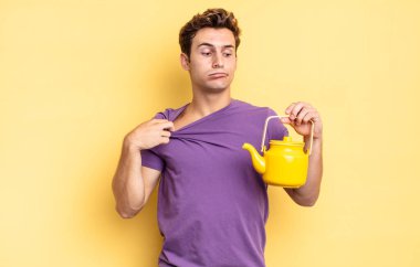 Stresli, endişeli, yorgun ve hayal kırıklığına uğramış, gömleğini çekmiş, sorunlu görünüyor. çaydanlık konsepti