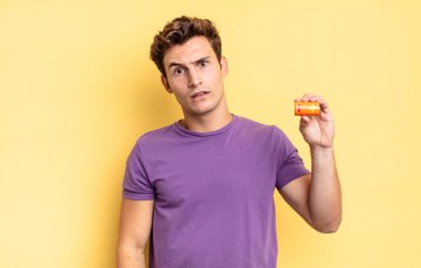 feeling puzzled and confused, with a dumb, stunned expression looking at something unexpected. battery concept