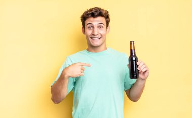 Mutlu, şaşkın ve gururlu hissediyorum. Heyecanlı ve şaşkın bir bakışla kendimi işaret ediyorum. bira şişesi konsepti
