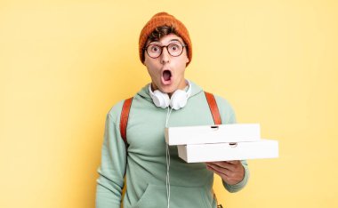 Şok olmuş ya da şaşırmış görünüyor, ağzı açık bir şekilde 