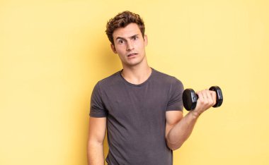 feeling puzzled and confused, with a dumb, stunned expression looking at something unexpected. dumbbell concept