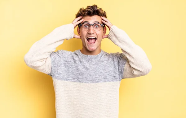 Young Teenager Boy Raising Hands Head Open Mouthed Feeling Extremely — Stock Photo, Image