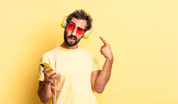 Expressive Crazy Man Feeling Confused Puzzled Showing You Insane Headphones — Stock Photo, Image