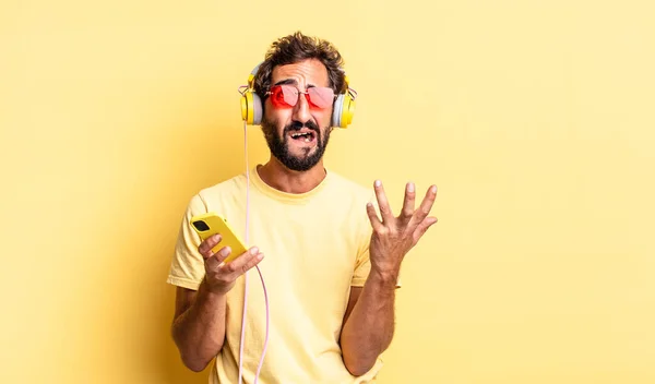 Expressiv Galen Man Ser Desperat Frustrerad Och Stressad Med Hörlurar — Stockfoto