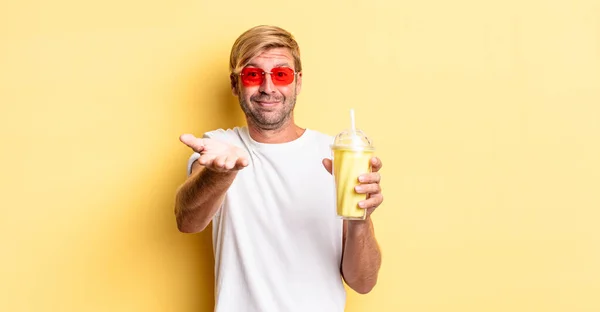 Blond Adult Man Smiling Happily Friendly Offering Showing Concept Milkshake — Stock Photo, Image