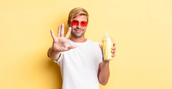 Blond Adult Man Smiling Looking Friendly Showing Number Five Milkshake — Stock Photo, Image