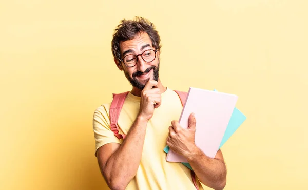 expressive crazy man smiling with a happy, confident expression with hand on chin. adult student concept