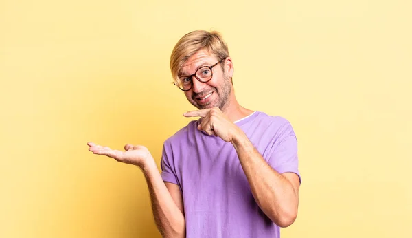 Handsome Blond Adult Man Smiling Cheerfully Pointing Copy Space Palm — Stock Photo, Image