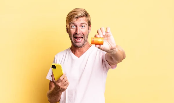 Blonde Handsome Adult Man Holding Batterie — Stock Photo, Image