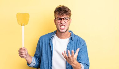 Genç ve yakışıklı bir adam sinirli, sinirli ve sinirli görünüyor. Sineklik konsepti