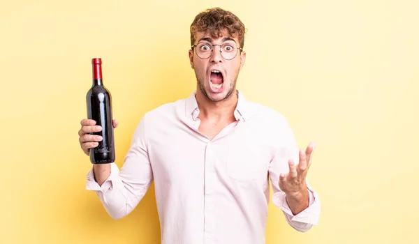 Young Handsome Man Amazed Shocked Astonished Unbelievable Surprise Wine Bottle — Stock Photo, Image