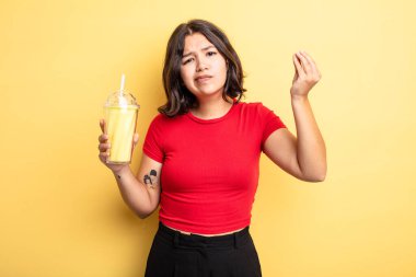 Genç ve güzel bir kadın kapiş ya da para hareketi yapıyor, sana ödemeni söylüyor. Milkshake konsepti